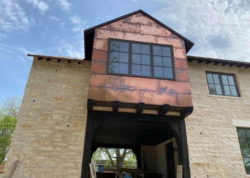 Copper metal panel facade on a stone building for Skylight Installation in Bensenville