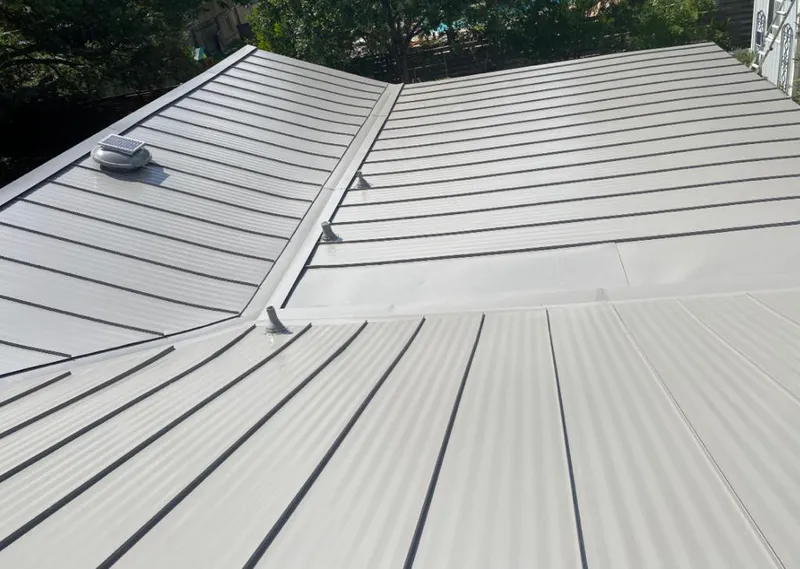 Solar attic fan installed on a metal roof for Roof Ventilation in Bensenville